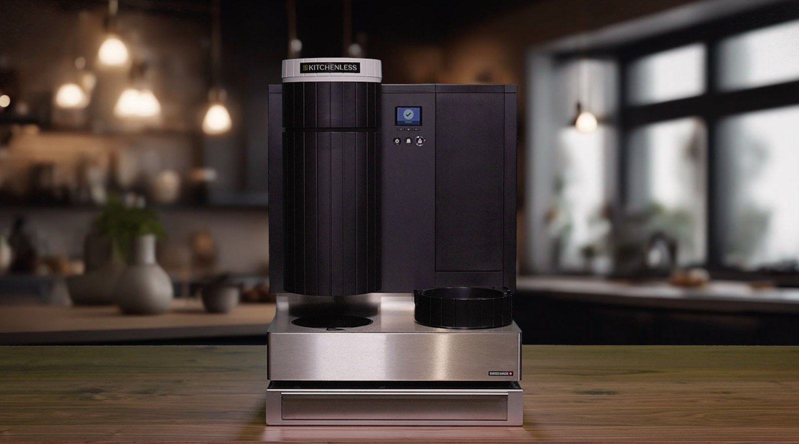 The Kitchenless Qeamer, a compact countertop cooking system, on a wooden counter in a warmly lit hospitality space